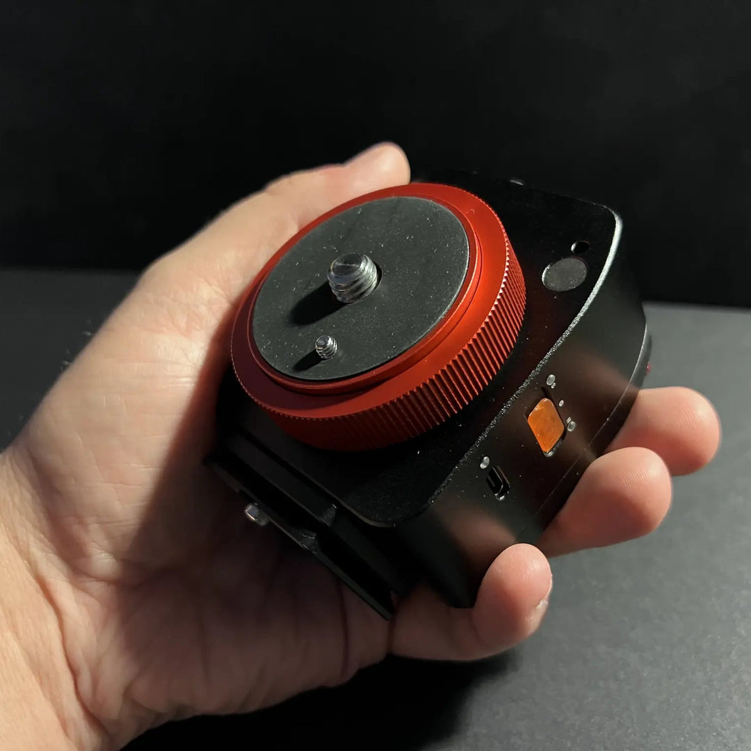 NOMAD tracker held by a hand