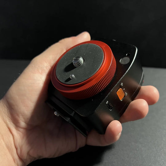 NOMAD tracker held by a hand